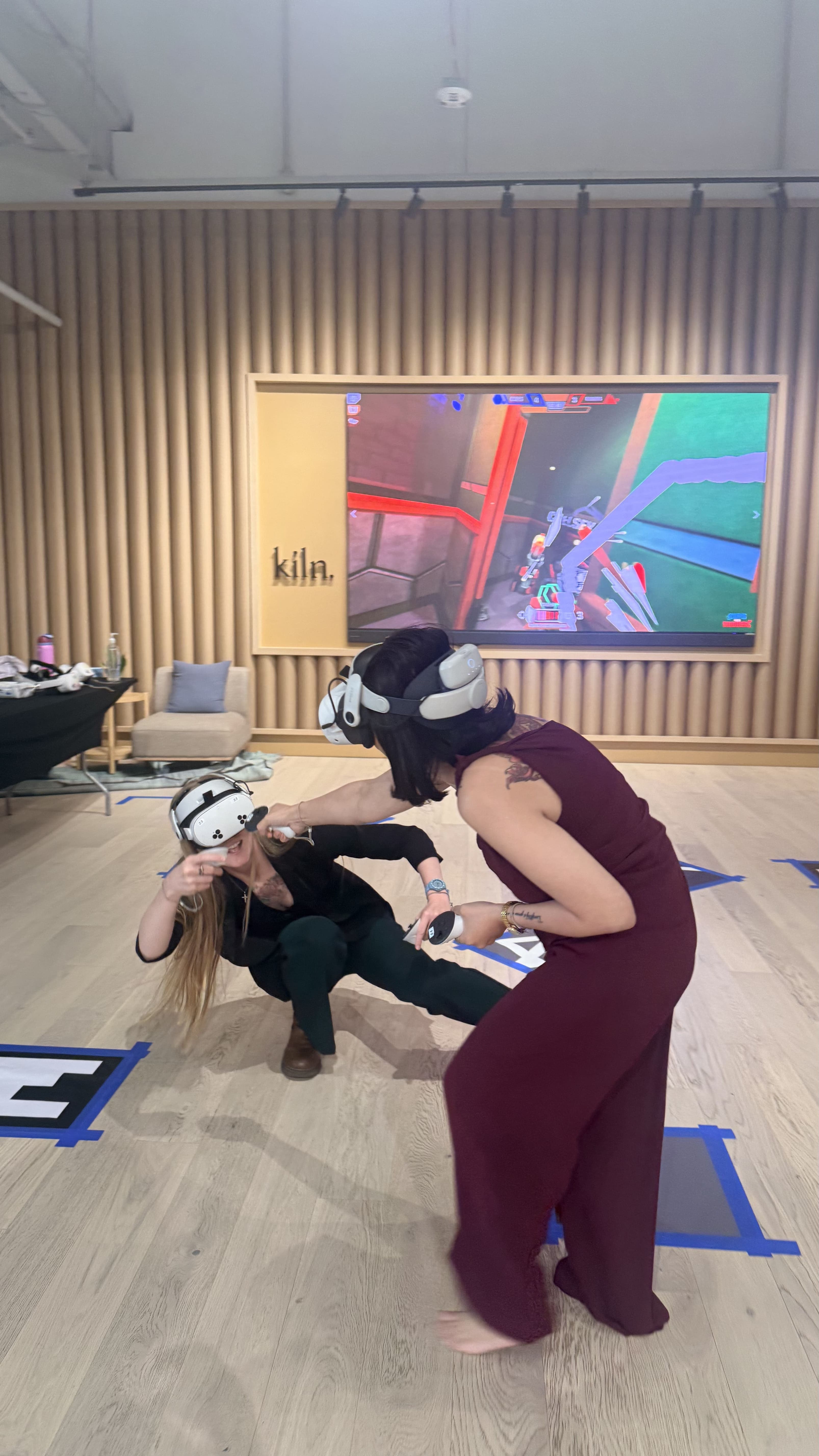 Two guests laughing while playing a VR game at a private event